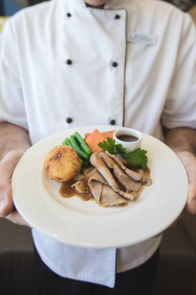 TriCare Food Chef holding roast meal portrait