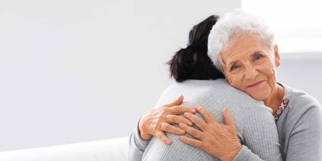 Aged Care mother and daughter hugging