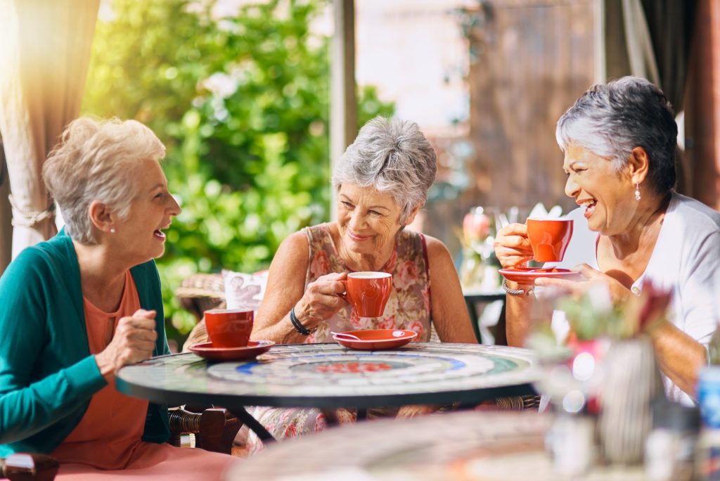 Retirement community women having tea and coffee