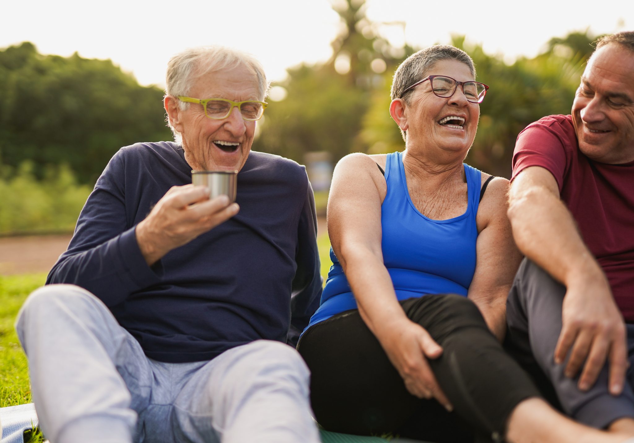 elderly health and wellness - group of seniors laughing together